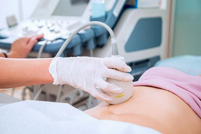 Hình ảnh một phụ nữ đang nói chuyện với bác sĩ sản phụ khoa trong phòng khám, nhấn mạnh tầm quan trọng của việc tìm kiếm tư vấn y tế khi thử que 2 vạch không có thai.